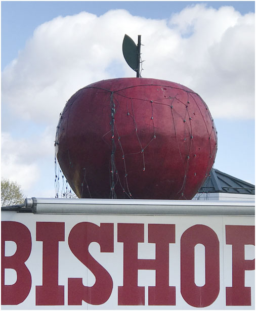 image of the large red apple atop Bishop's market